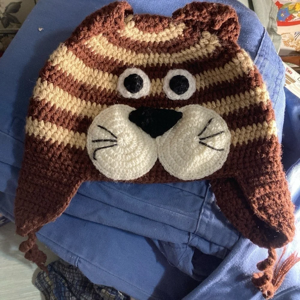Crochet cat hat with ear flaps      New                 there’s a cat in my lap